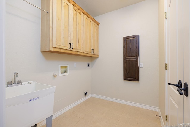 laundry area with hookup for a washing machine, a sink, electric dryer hookup, cabinet space, and baseboards