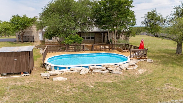 outdoor pool with a lawn, a shed, and a deck