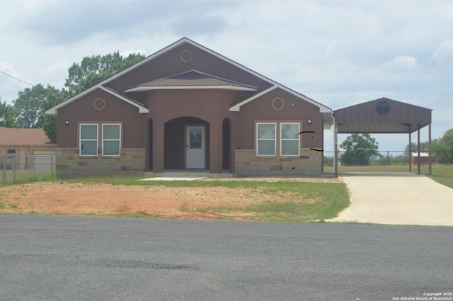 18687 Rolling Mdw, Lytle, TX 78052 - ranch-style house featuring stucco siding, fence, driveway, and a detached carport