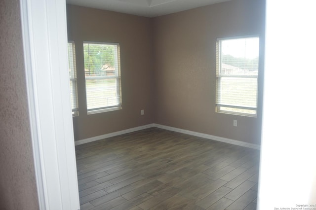 18687 Rolling Mdw, Lytle, TX 78052 - unfurnished room with baseboards and dark wood-type flooring