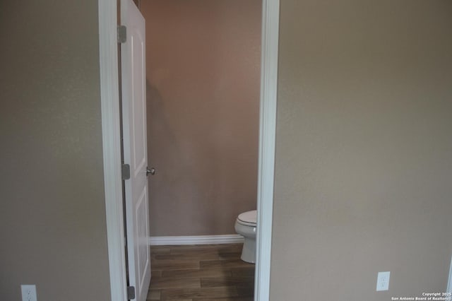 18687 Rolling Mdw, Lytle, TX 78052 - bathroom featuring toilet, wood finished floors, and baseboards