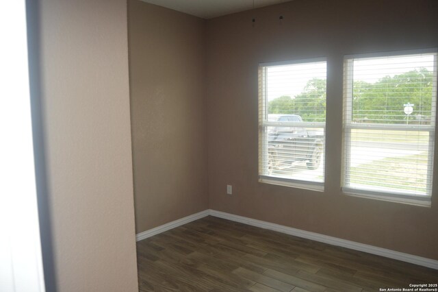 18687 Rolling Mdw, Lytle, TX 78052 - spare room featuring baseboards, a healthy amount of sunlight, and dark wood-style floors