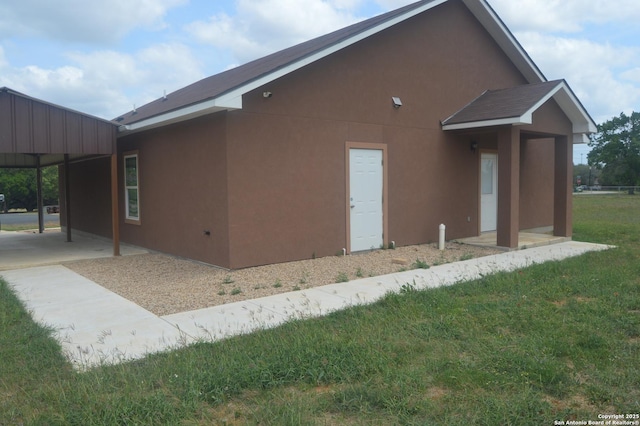 18687 Rolling Mdw, Lytle, TX 78052 - view of side of property with stucco siding and a yard