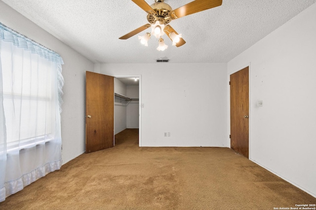 16759 County Road 1726, Odem, TX 78370 - unfurnished bedroom featuring carpet floors, a textured ceiling, and multiple windows