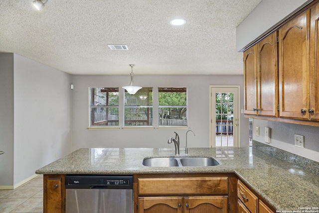 kitchen with a sink, a textured ceiling, brown cabinets, dishwasher, and a peninsula