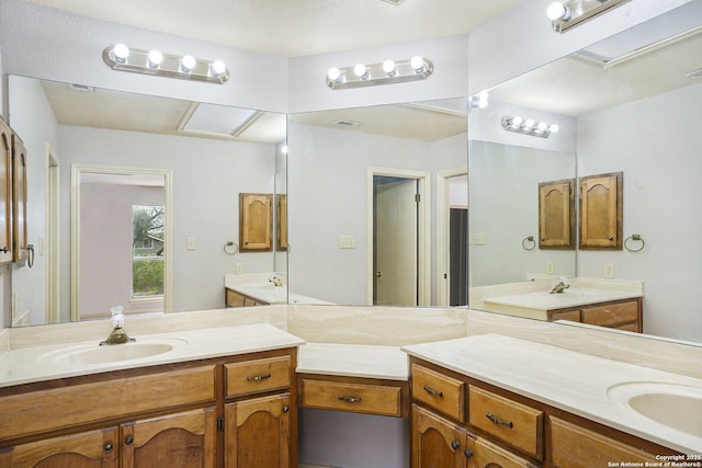 full bath featuring two vanities and a sink