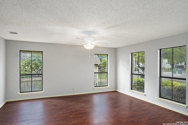 spare room featuring baseboards, a ceiling fan, and wood finished floors