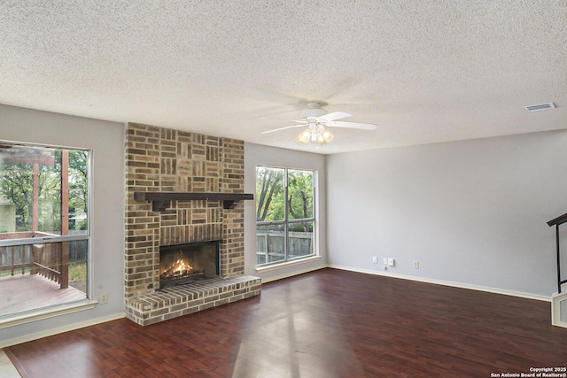 unfurnished living room with wood finished floors, visible vents, ceiling fan, and plenty of natural light