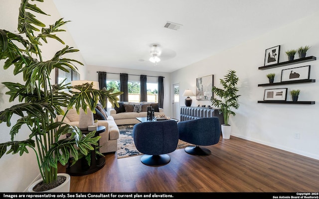 living room featuring baseboards, wood finished floors, and visible vents