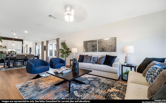 living room with recessed lighting, visible vents, a ceiling fan, and wood finished floors