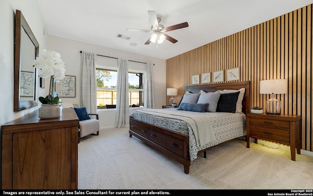 bedroom with baseboards, visible vents, a ceiling fan, and light colored carpet
