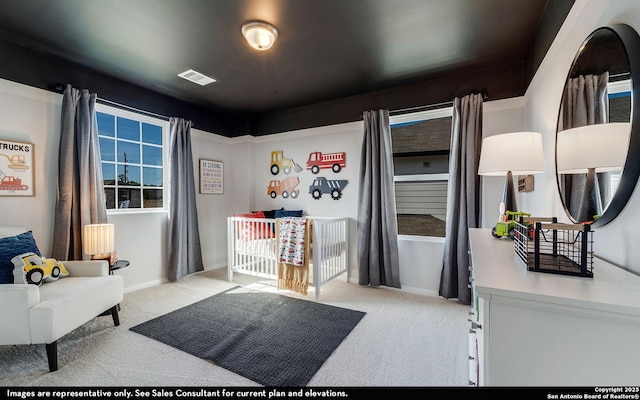 carpeted bedroom with visible vents and baseboards