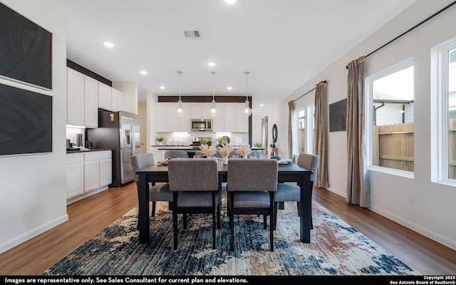 dining area featuring visible vents, baseboards, recessed lighting, and wood finished floors