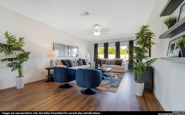 living room with baseboards, wood finished floors, visible vents, and a ceiling fan