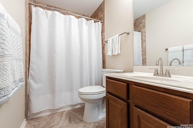 bathroom featuring toilet and vanity