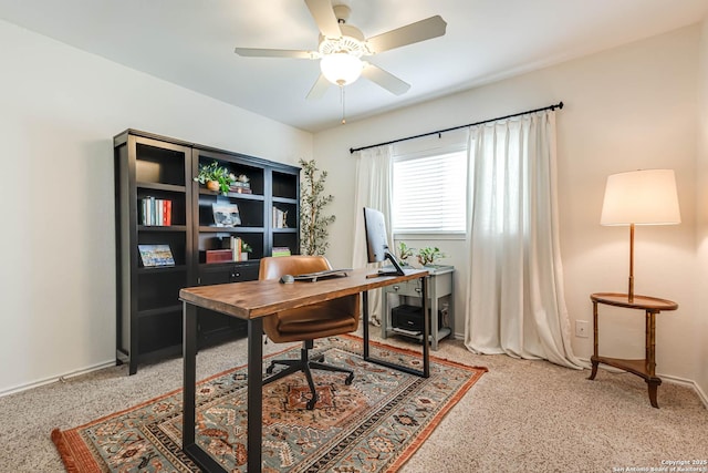 home office featuring ceiling fan, light colored carpet, and baseboards