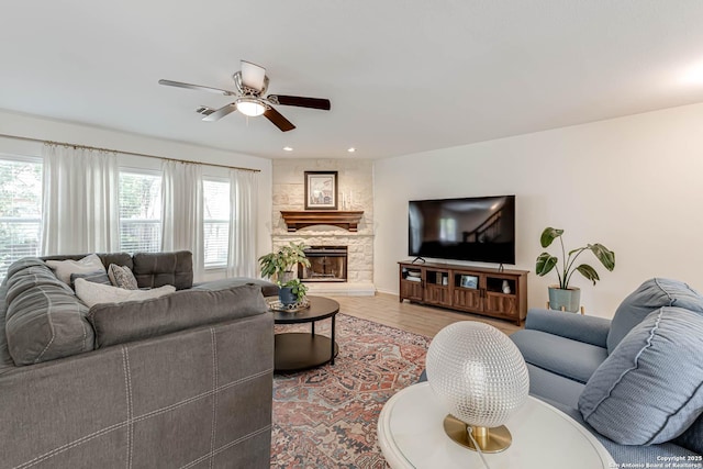 living room with a fireplace, a ceiling fan, recessed lighting, and wood finished floors