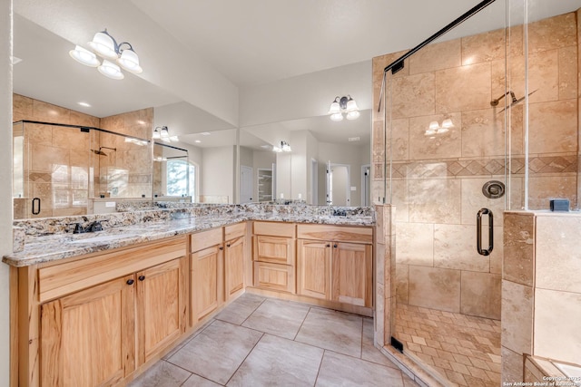 full bath featuring a sink, a shower stall, and double vanity
