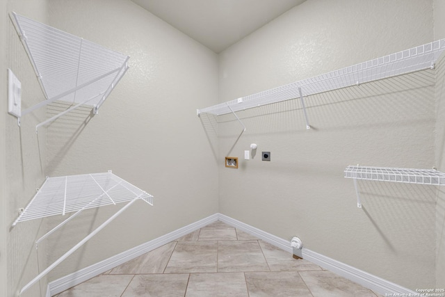 washroom featuring hookup for a washing machine, baseboards, electric dryer hookup, and laundry area