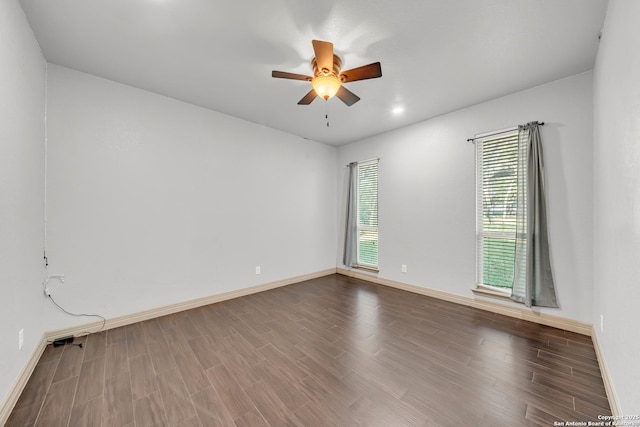 unfurnished room featuring wood finished floors, baseboards, and ceiling fan