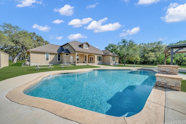 pool featuring a yard and a patio
