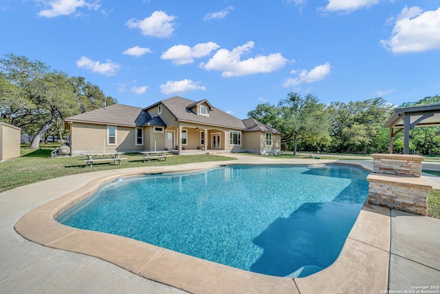 pool with a lawn and a patio