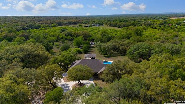 birds eye view of property featuring a view of trees