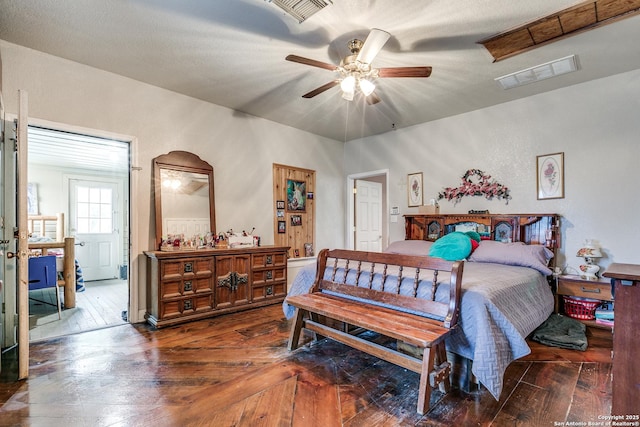 bedroom with hardwood / wood-style flooring, visible vents, and ceiling fan