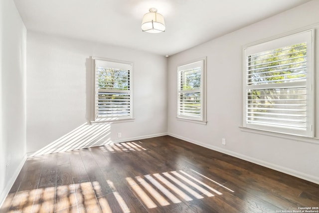 empty room with hardwood / wood-style flooring and baseboards