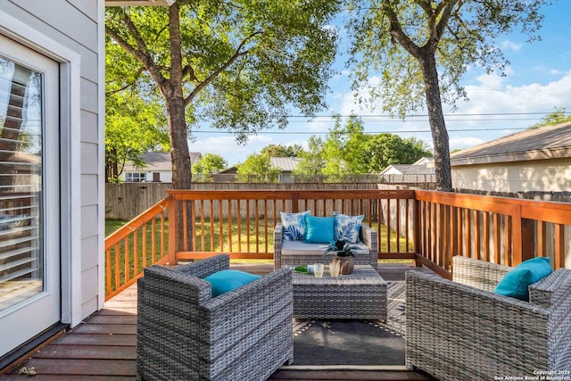 deck with outdoor lounge area and a fenced backyard