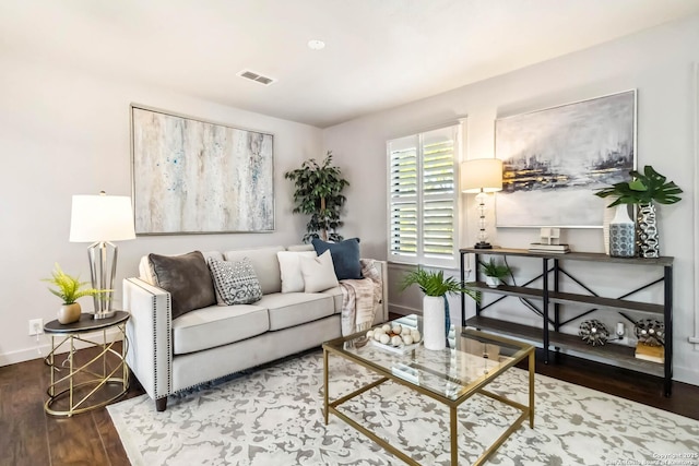 living room with baseboards, wood finished floors, and visible vents