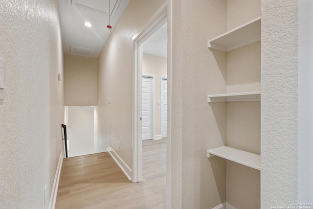 114 S Minter St, San Antonio, TX 78207 - hallway with attic access, a textured wall, and wood finished floors