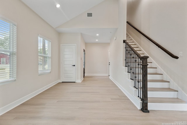 114 S Minter St, San Antonio, TX 78207 - foyer with stairs, baseboards, visible vents, and light wood-style floors