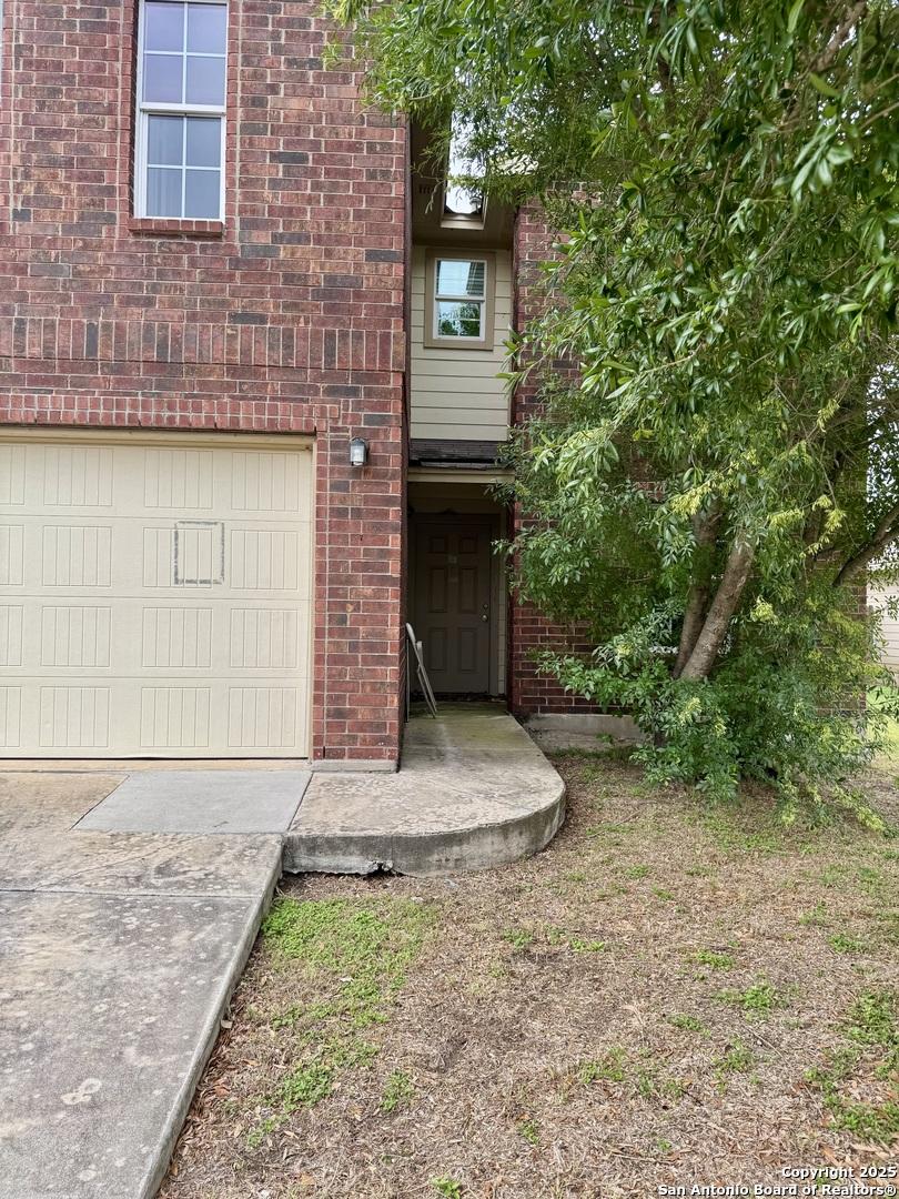 814 Six Iron, San Antonio, TX 78221 - view of front of property with brick siding and a garage