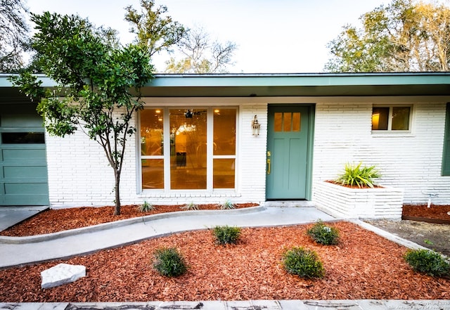 905 E Inez, Beeville, TX 78102 - property entrance featuring brick siding and a garage