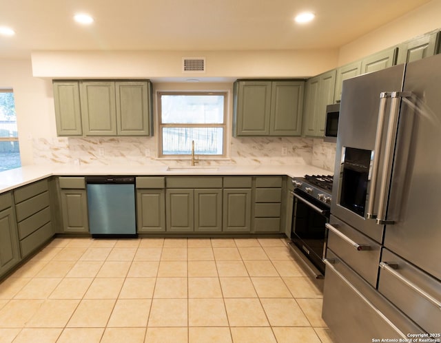 905 E Inez, Beeville, TX 78102 - kitchen featuring stainless steel appliances, visible vents, a sink, and backsplash