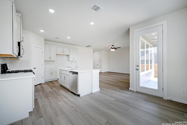 6031 Calgary Park, San Antonio, TX 78233 - kitchen with stainless steel appliances, a sink, decorative backsplash, ceiling fan, and white cabinets