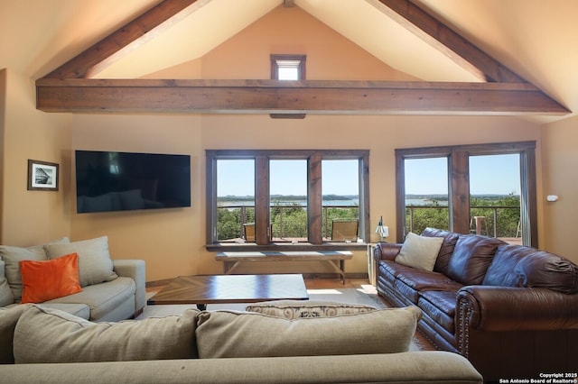 living room featuring beamed ceiling and high vaulted ceiling