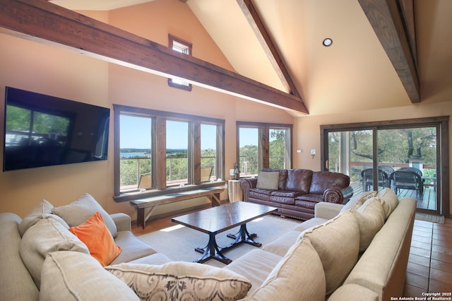 living area featuring beamed ceiling, a wealth of natural light, and high vaulted ceiling