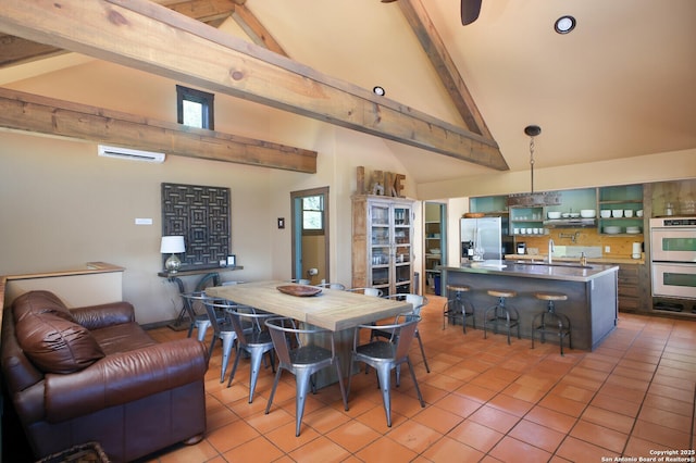 dining room with beam ceiling, high vaulted ceiling, and light tile patterned floors