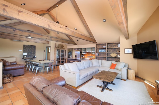 living room featuring lofted ceiling with beams and light tile patterned floors