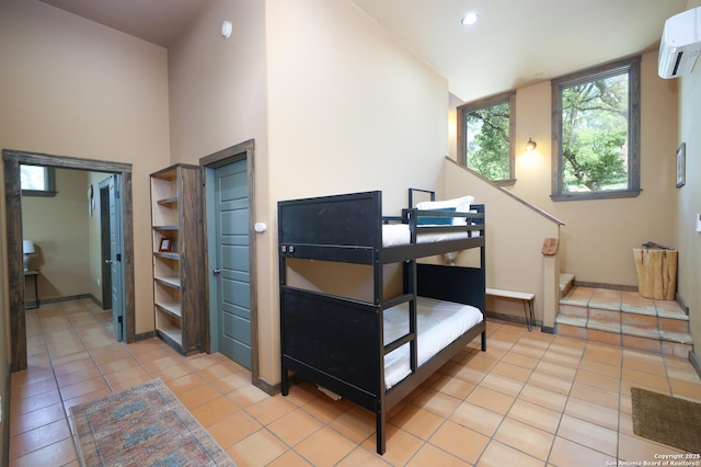 interior space featuring baseboards, a wall mounted AC, recessed lighting, and light tile patterned flooring