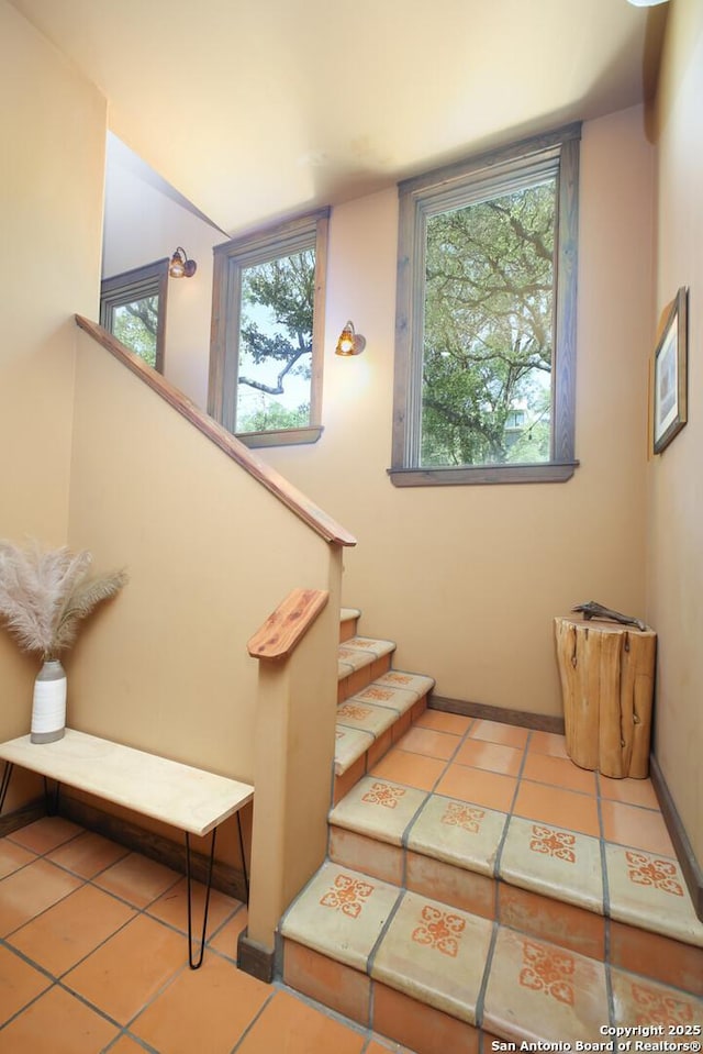 stairs with tile patterned flooring and baseboards