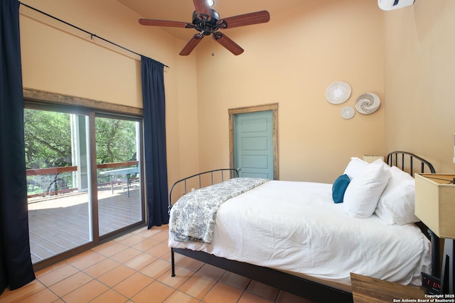 bedroom featuring light tile patterned flooring, high vaulted ceiling, and access to exterior