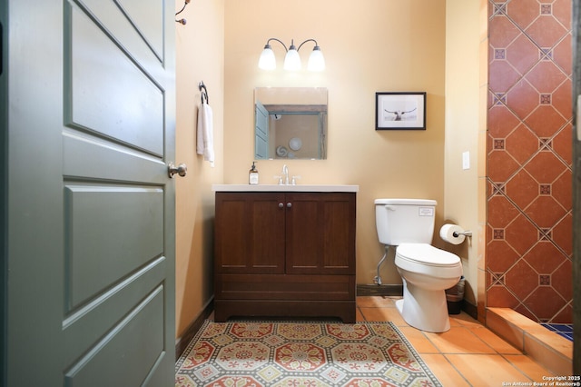 full bath featuring tile patterned flooring, vanity, toilet, and baseboards
