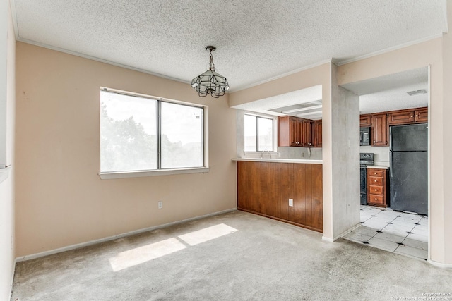 unfurnished dining area with light colored carpet, a notable chandelier, and a textured ceiling