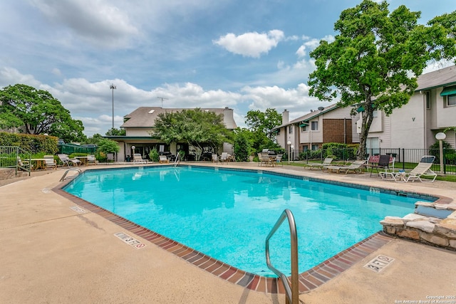 pool featuring fence and a patio