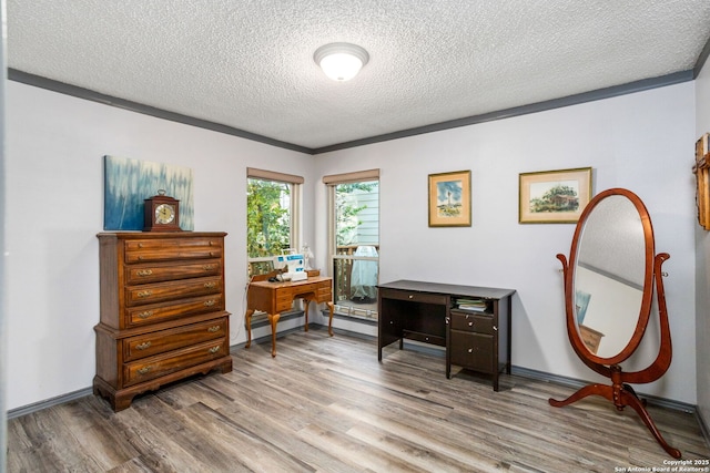home office featuring baseboards, wood finished floors, and a textured ceiling