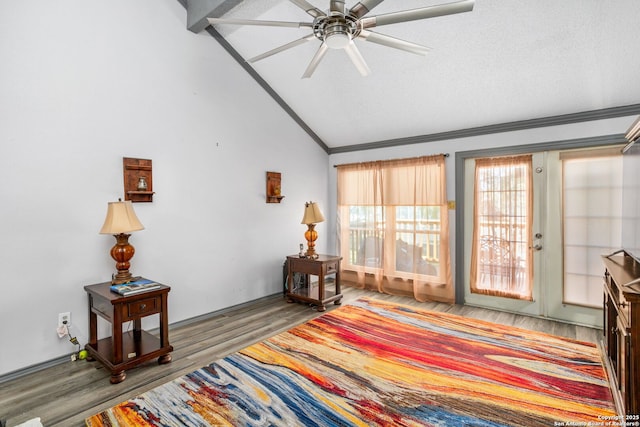 bedroom featuring vaulted ceiling, crown molding, and wood finished floors