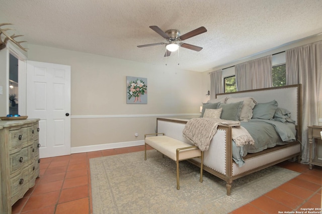 tiled bedroom with a textured ceiling and a ceiling fan